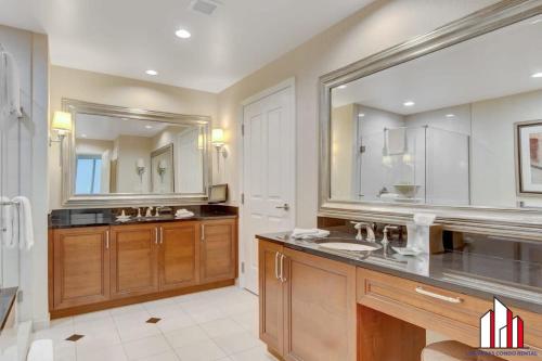 a bathroom with a sink and a large mirror at MGM Signature-19-802 1Br 2Ba F1 Pits View Balcony in Las Vegas