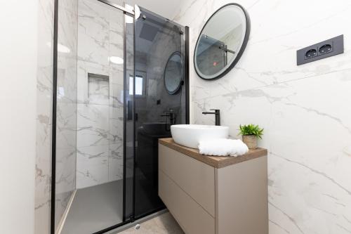 a bathroom with a sink and a shower at Villa Koludrovac in Kaštela