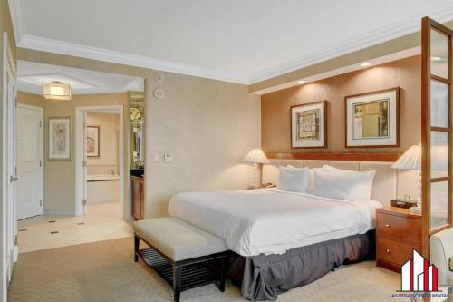 a hotel room with a large bed and a chair at MGM Signature-25-609 Strip View Jacuzzi Studio in Las Vegas