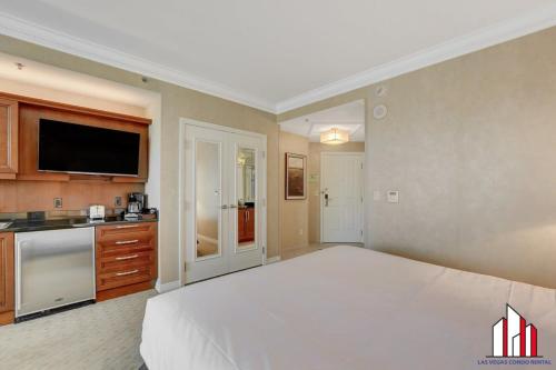 a large bedroom with a large bed and a kitchen at MGM Signature-25-609 Strip View Jacuzzi Studio in Las Vegas