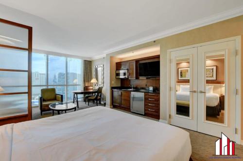 a hotel room with a bed and a living room at MGM Signature-25-609 Strip View Jacuzzi Studio in Las Vegas