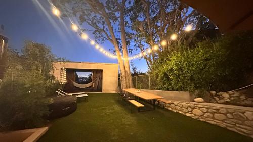 a garden with a bench and a tree with lights at Echo Park Hills in Los Angeles