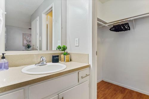 a bathroom with a sink and a mirror at Central Austin Studio Pets Allowed and Free Prkg in Austin