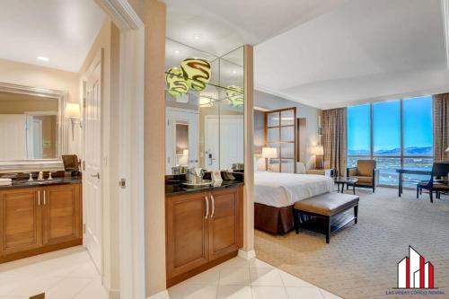 a bedroom with a bed and a bathroom with a view at MGM Signature-31-704 Jacuzzi Studio in Las Vegas