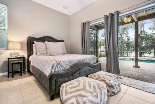 um quarto com uma cama e uma grande janela em Pool + Hot Tub, Dock, Fishing, Near Beach! em Saint Augustine