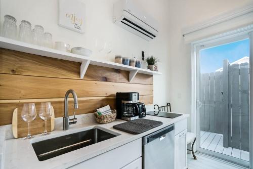 a kitchen with a sink and a counter top at Mod Studio - 100 Steps to the Beach, Pets OK, Private Deck! in St. Augustine