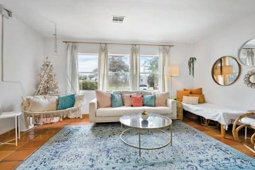 a living room with a couch and a table at Pink House Prime Location Walk to Downtown Dogs OK in St. Augustine