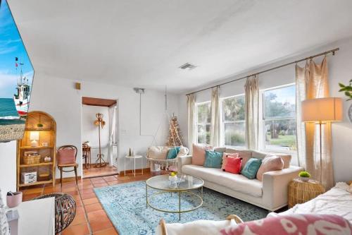 a living room with a couch and a table at Pink House Prime Location Walk to Downtown Dogs OK in St. Augustine