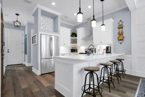 a kitchen with a white counter and bar stools at Blue House, Prime Location, Family Amenities, BBQ! in St. Augustine