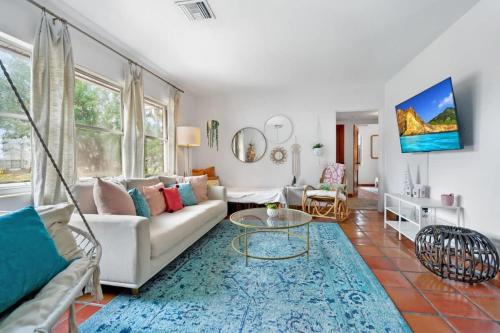a living room with a couch and a table at Pink House Prime Location Walk to Downtown Dogs OK in St. Augustine