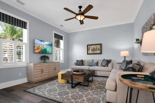 a living room with a couch and a ceiling fan at Blue House, Prime Location, Family Amenities, BBQ! in St. Augustine