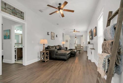 a living room with a couch and a ceiling fan at Charming Cottage w Pool, Walkable to Downtown in St. Augustine