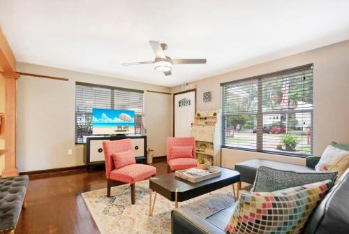 a living room with a couch and chairs and a tv at Eclectic Beauty, Heart of Downtown St Aug in Saint Augustine