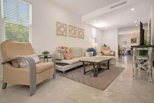 a living room with a couch and a table at Downtown Home with Hot Tub, BBQ, Near Ice Plant! in Saint Augustine