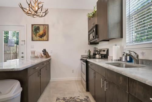 a kitchen with a sink and a counter top at Downtown Home with Hot Tub, BBQ, Near Ice Plant! in Saint Augustine