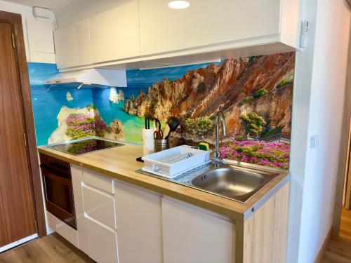 a kitchen with a sink and a painting on the wall at SANTA BEACH in Roses