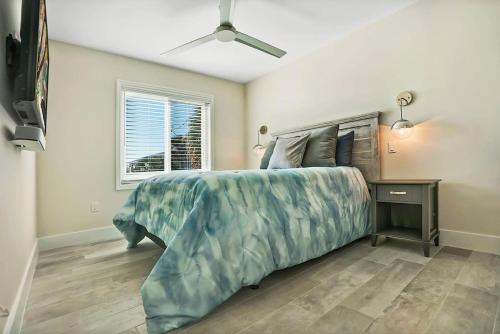 a bedroom with a large bed and a window at Ocean Views Retreat! Renovated Apt with Beach Bikes! in Saint Augustine