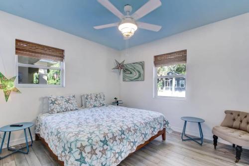 a bedroom with a bed and a ceiling fan at Uptown Treasure with Spa Dogs Ok Dreamy Patio in St. Augustine