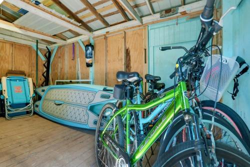 a bike parked in a garage next to a car at Charming Fishing Cabin Has It All, Full Dock and Summer Kitchen, Access to SUPs, Bikes, Beach Gear in Palm Coast