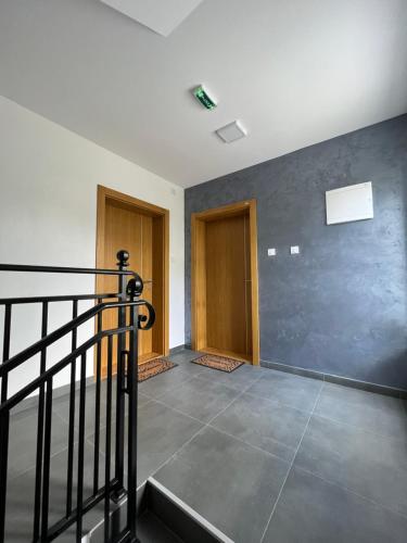 an empty hallway with a staircase in a house at Verde Apartman Sokobanja in Soko Banja