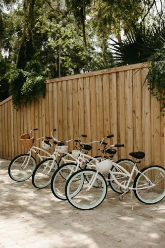 a group of bikes parked next to a fence at Remodeled Historic 1800s Carriage House, The Castle Garden, Colonial Modern Mansion in St. Augustine