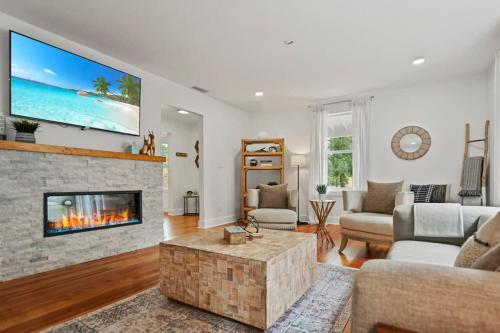 a living room with a couch and a fireplace at Remodeled Historic 1800s Carriage House, The Castle Garden, Colonial Modern Mansion in St. Augustine