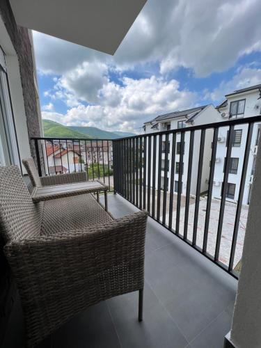 a balcony with chairs and a view of the ocean at Verde Apartman Sokobanja in Soko Banja