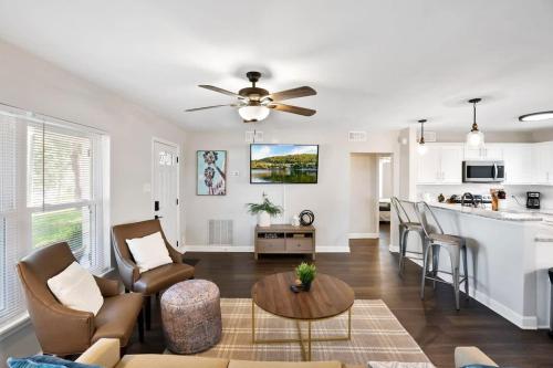 a living room and kitchen with a ceiling fan at Rave Reviews for Waterway Views Spa Comfy Beds Bring Your Boat in Saint Augustine