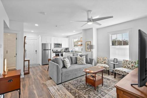 a living room with a couch and a kitchen at City Living West Downtown St Aug Apartment in St. Augustine