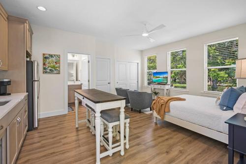 a bedroom with a bed and a desk and a kitchen at New Private Apt in Uptown St Aug Walk Everywhere in St. Augustine
