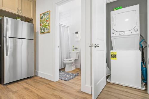 a white kitchen with a refrigerator and a toilet at New Private Apt in Uptown St Aug Walk Everywhere in St. Augustine