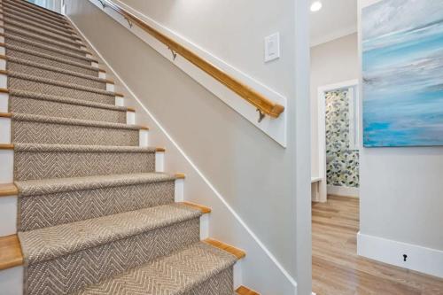 a staircase in a home with a painting on the wall at Lincolnville Luxe Upscale Home in Heart of St Aug in St. Augustine