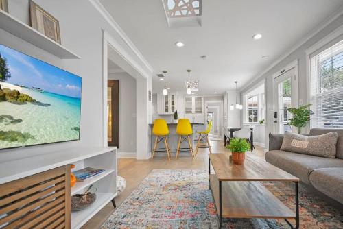 a living room with a couch and a tv at Onyx House King Size Beds Bikes Games Wine in St. Augustine