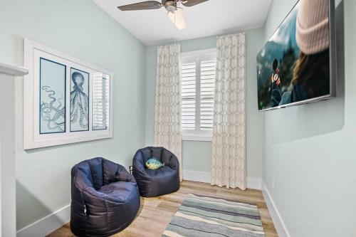 a living room with two chairs and a ceiling fan at Lincolnville Luxe Upscale Home in Heart of St Aug in St. Augustine