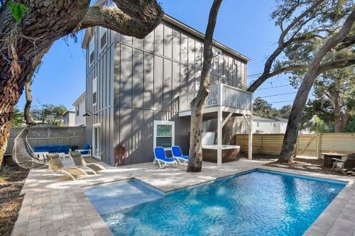 a swimming pool in front of a house at Downtown St Aug Home by Fountain of Youth Pool Spa by Beach Add Golf Cart in St. Augustine
