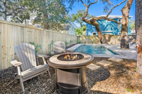 a backyard with two chairs and a fire pit at Downtown St Aug Home by Fountain of Youth Pool Spa by Beach Add Golf Cart in St. Augustine