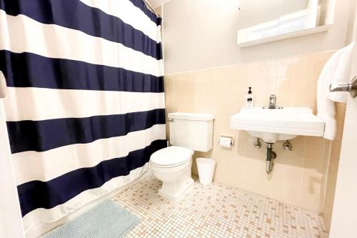 a bathroom with a toilet and a sink at 2BR and 2BA Beer City Flat with Pool Gym and Parking in Grand Rapids