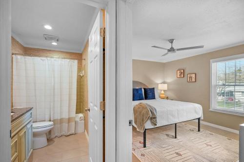 a bedroom with a bed and a bathroom at Dog Friendly Condo Moon and Stars Walk to DT Patio in Saint Augustine
