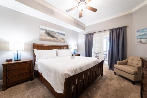 a bedroom with a large bed and a chair at Phoenix West II 2307 Lazy River + Waterslide in Orange Beach