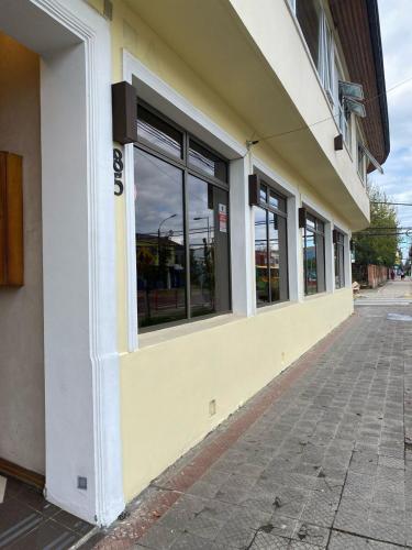 a store front with windows on the side of a building at Hotel Libertador Bernardo O´Higgins in Chillán