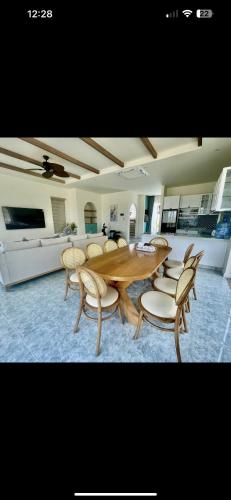 a wooden table and chairs in a living room at Blue Village in Bình Tú