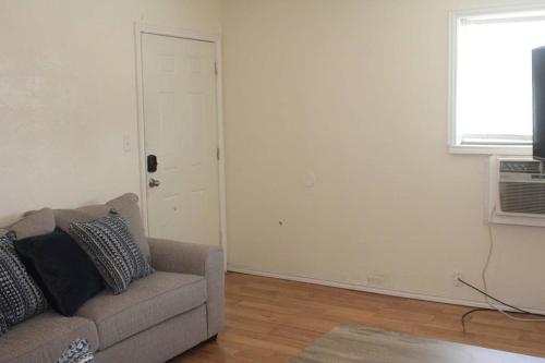 a living room with a couch and a window at 1 bedroom apartment within sight of Fort. Sill in Lawton
