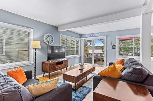 a living room with a couch and a tv at 4 BR 2 BA Peaceful Getaway Year Round on Park Lake in Bath