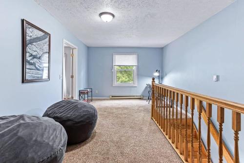 a room with blue walls and a wooden staircase at 4 BR 2 BA Peaceful Getaway Year Round on Park Lake in Bath