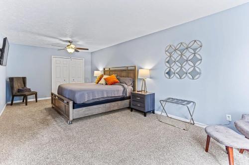 a bedroom with blue walls and a bed with orange pillows at 4 BR 2 BA Peaceful Getaway Year Round on Park Lake in Bath