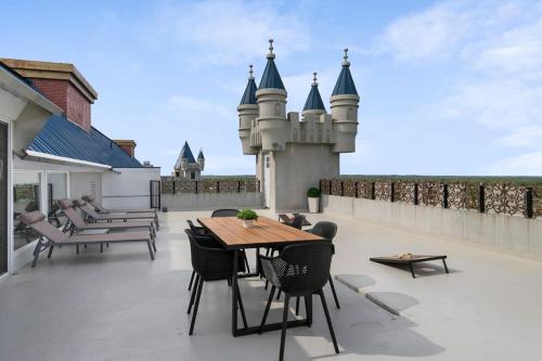 a patio with a table and chairs and a castle at Extravagant 3 Level Penthouse at The Grand Castle in Grandville