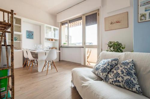 a living room with a couch and a table at [Seaside Apt] Private Parking and near the beach in Viareggio