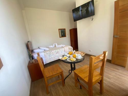 a small room with a table and chairs and a bed at HOTEL HACIENDA SUBTANJALLA CASABLANCA in El Cambio