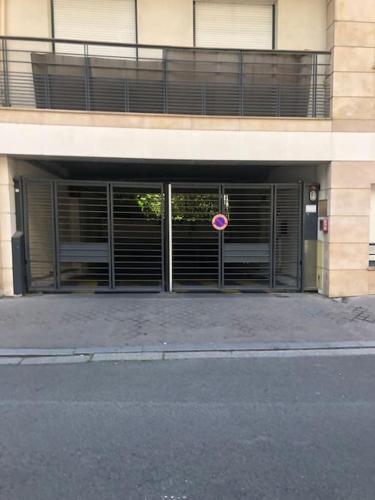 un bâtiment avec des portes avec un panneau devant dans l'établissement Studio avec parking privé et métro, à Boulogne-Billancourt