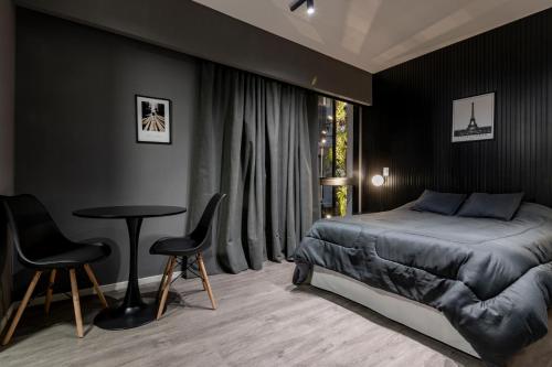 Кровать или кровати в номере Monoambiente Simil Hotel Lujoso